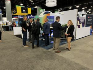 Bamboo Health team talks to other ViVE attendees at booth