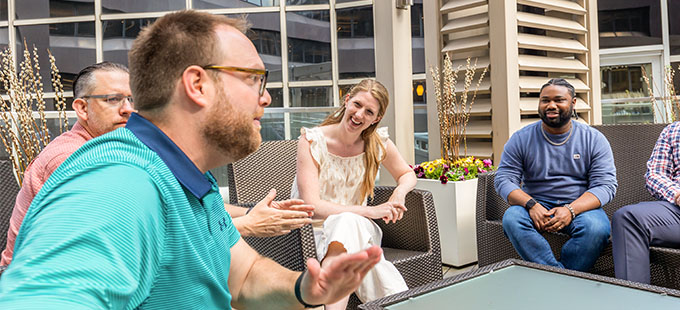 Bamboo Health employees laughing and talking on an outside patio